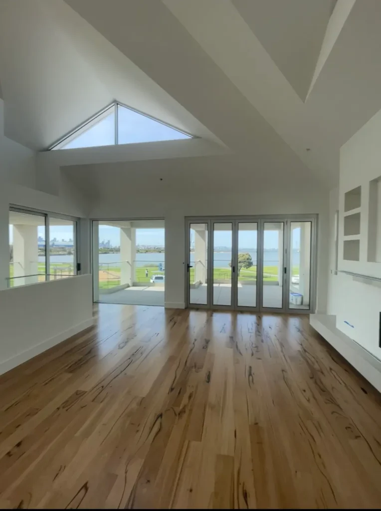 Bright modern living room with fresh white walls and timber flooring.